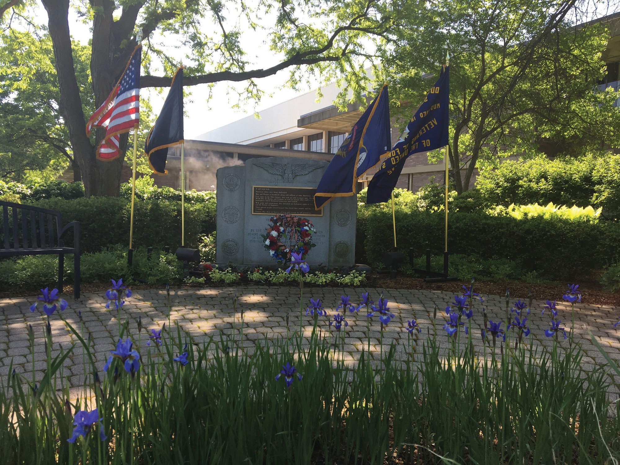 Courtyard headstone with flowers and flags 