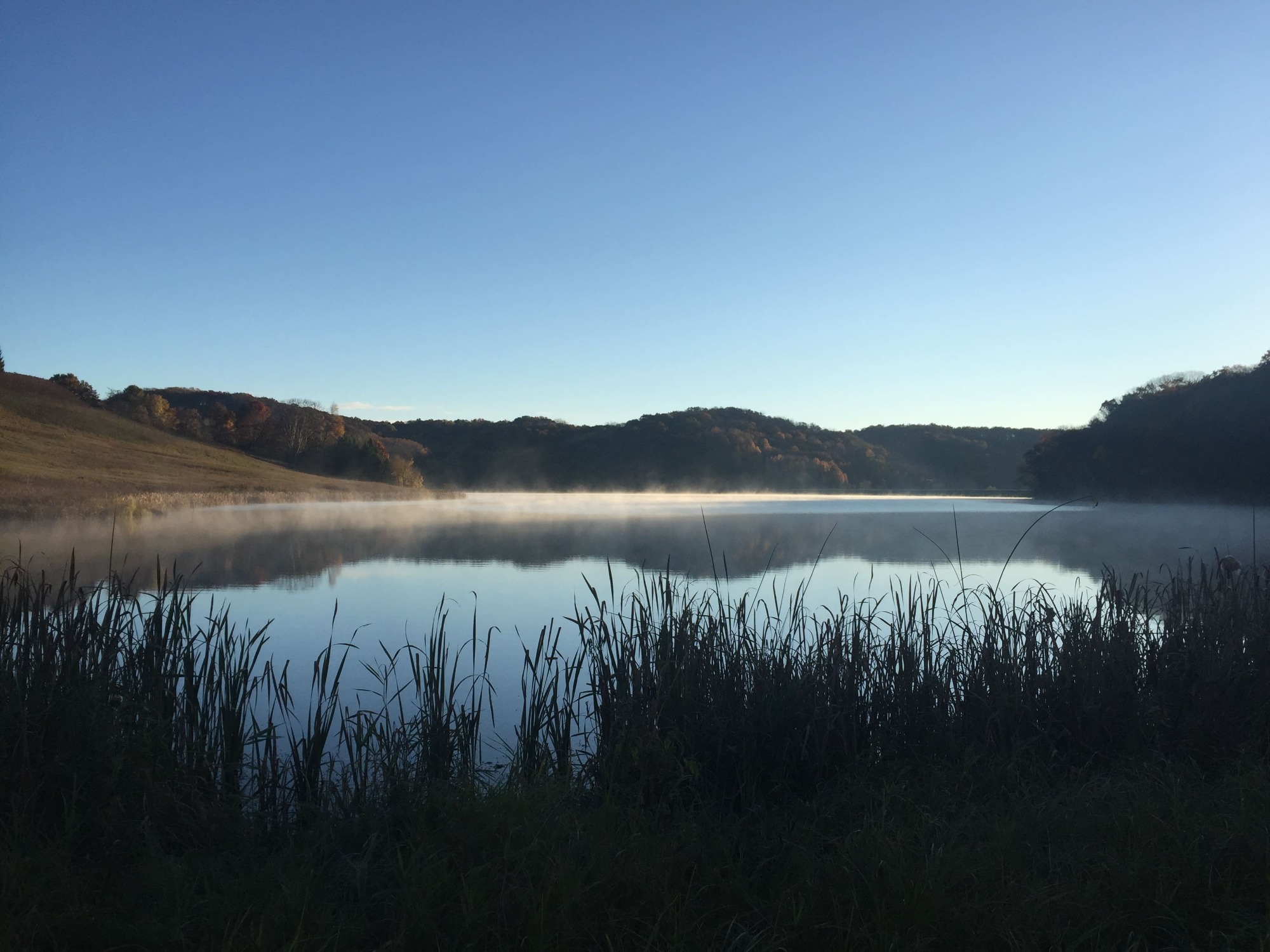 Picture of lake with fog coming off the top