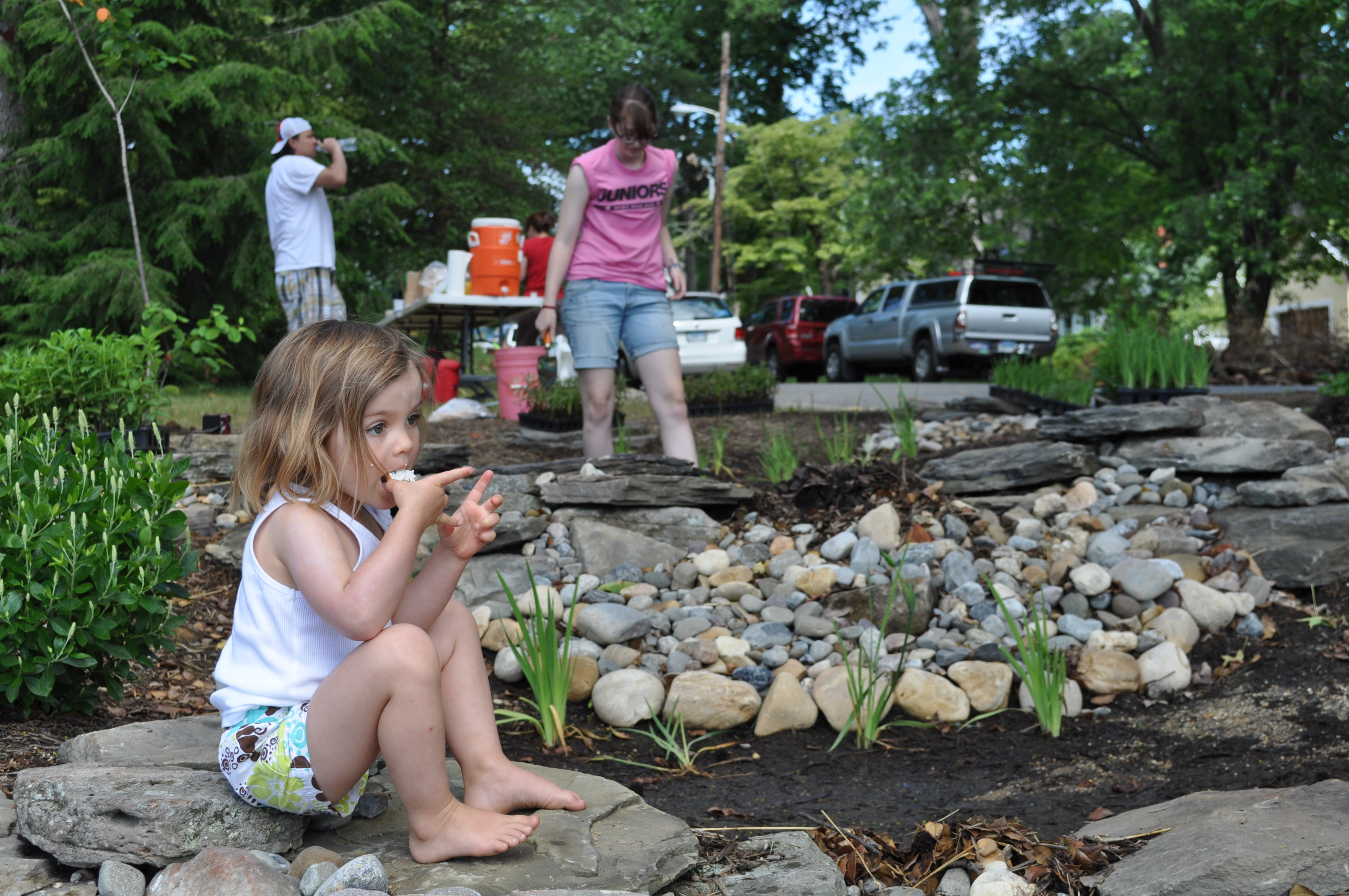small child sitting on stones